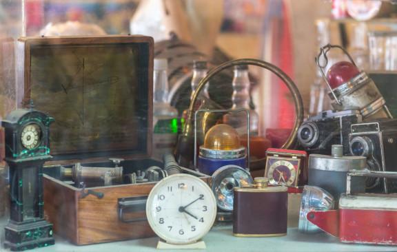 Vintage collectibles display at St Charles Antique Mall featuring clocks, cameras, and antique decor items