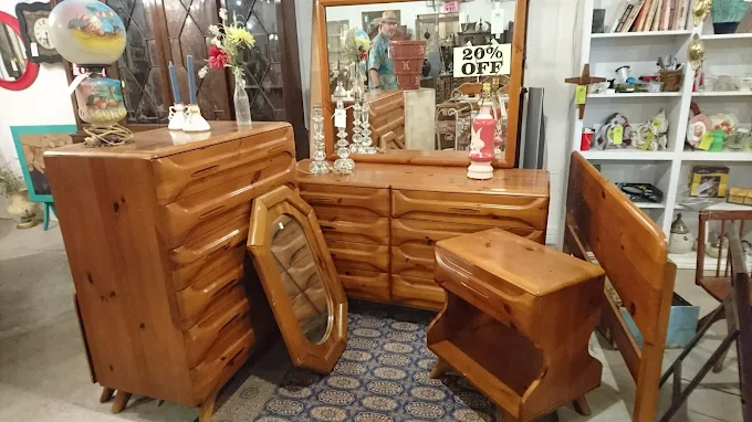 Vintage wooden bedroom furniture set displayed inside Highway Pickers Antique Mall flea market