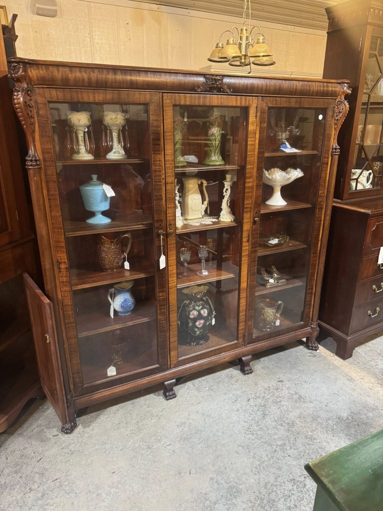Large antique wooden display cabinet with vintage collectibles at Highway Pickers Antique Mall