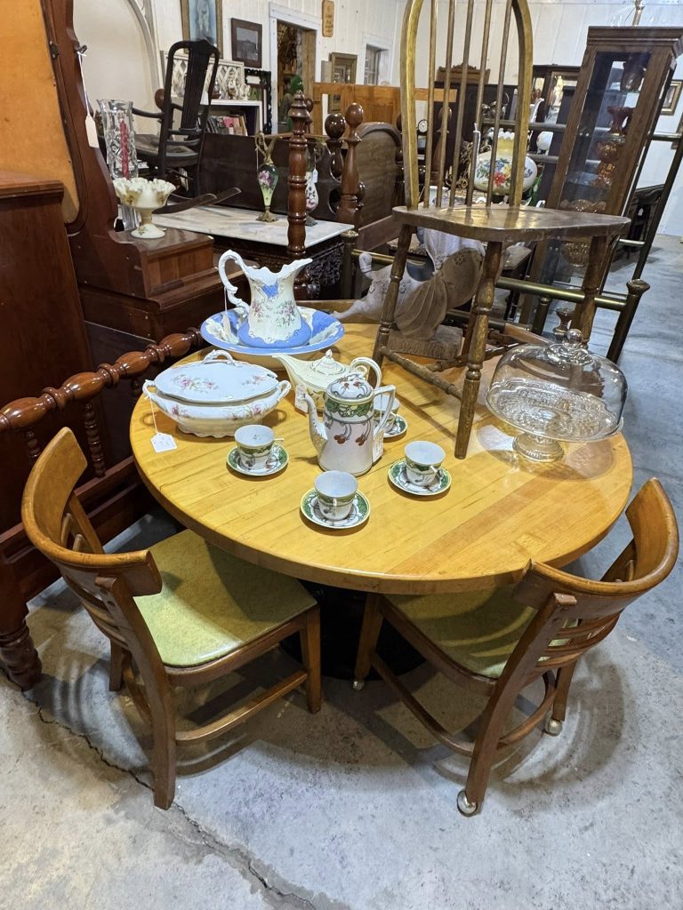 Vintage wooden dining table and antique furniture display at Highway Pickers Antique Mall in Cullman Alabama
