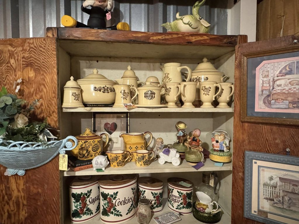 Vintage kitchenware and ceramic dish collection displayed in a vendor booth at Highway Pickers Antique Mall