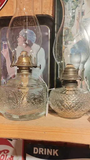 Vintage glass oil lamps displayed in a collectibles booth at Highway Pickers Antique Mall flea market