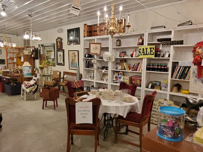 Vintage dining table and antique chairs displayed in a furniture section at Highway Pickers Antique Mall