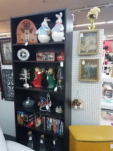 Vintage collectibles, figurines, and antique décor displayed on a vendor shelf at Timeless Antiques & Flea Mall in Valley Alabama.