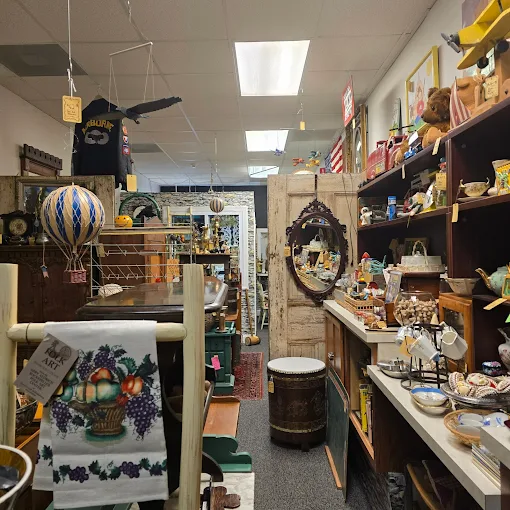 Vendor booth filled with antiques, collectibles, and vintage decor items inside Two Crows Antique Mall in Ranson WV.