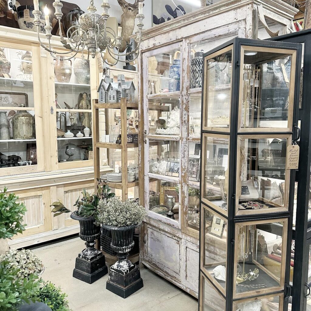 Antiques and collectibles on display at The Agoura Antique Mart in Agoura Hills, including clocks, books, and folk art.