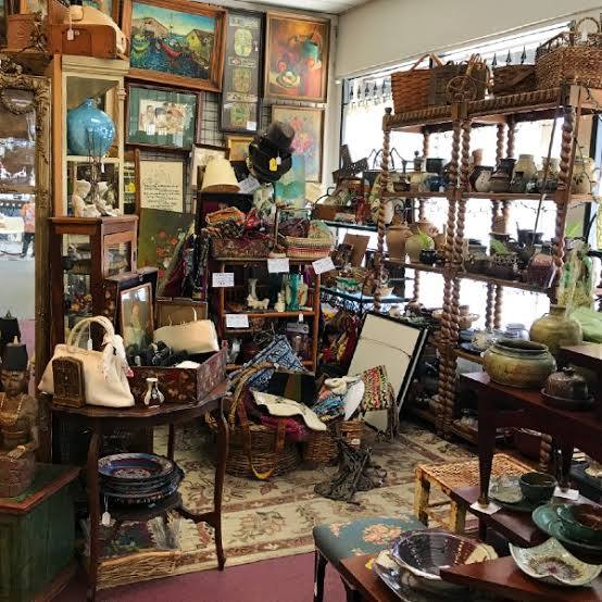 Collection of antique furniture at Pasadena Antique Mall featuring vintage wooden tables, ornate chairs, and classic home décor pieces.