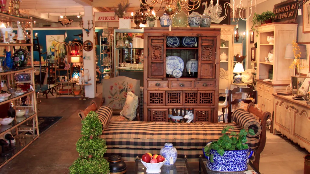 Exterior view of Pasadena Antique Mall in Old Pasadena featuring vintage furniture, antique décor, and local shoppers browsing.