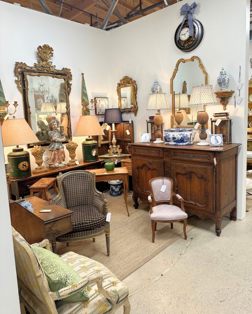 Vintage mirrors, lamps, and lighting fixtures displayed inside The Agoura Antique Mart in Whizin Market Square.