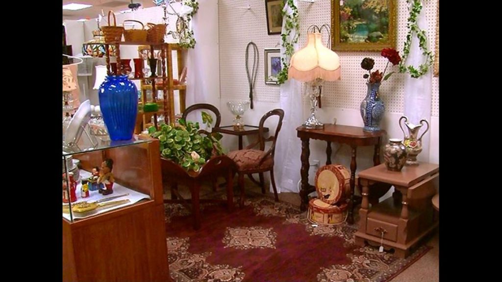 Antique furniture and vintage décor displayed inside Maumee Antique Mall with organized dealer booths and wide indoor aisles.
