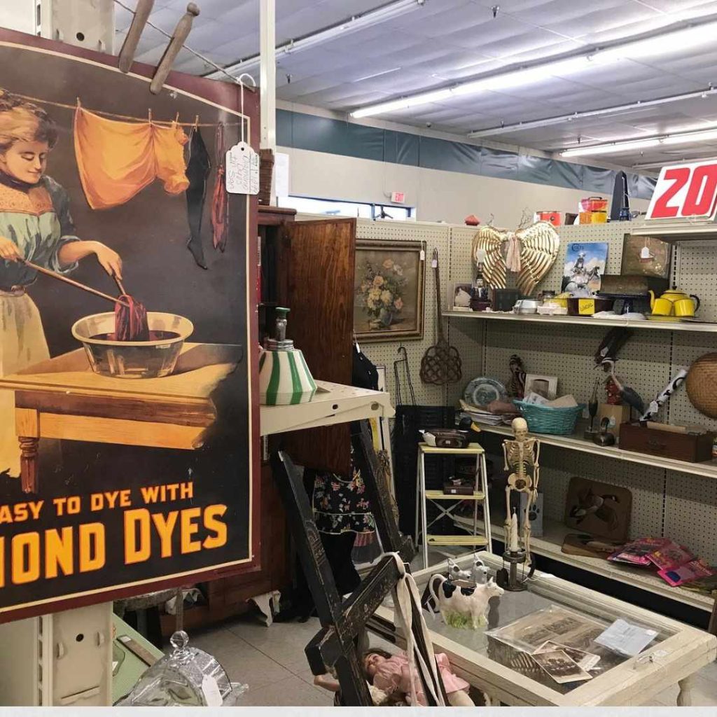 Antique furniture and vintage décor displayed inside Maumee Antique Mall with organized dealer booths and wide indoor aisles.