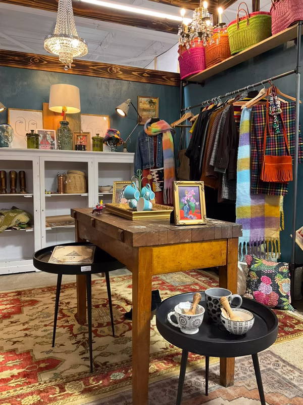 Independent dealer booths and collectible display cases inside Maumee Antique Mall featuring antiques, jewelry, and vintage finds.