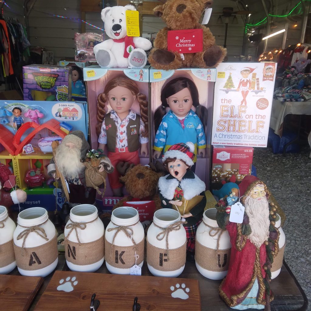 Rutledge Flea Market vendor booth displaying dolls, teddy bears, and Christmas decorations in Rutledge Missouri flea market