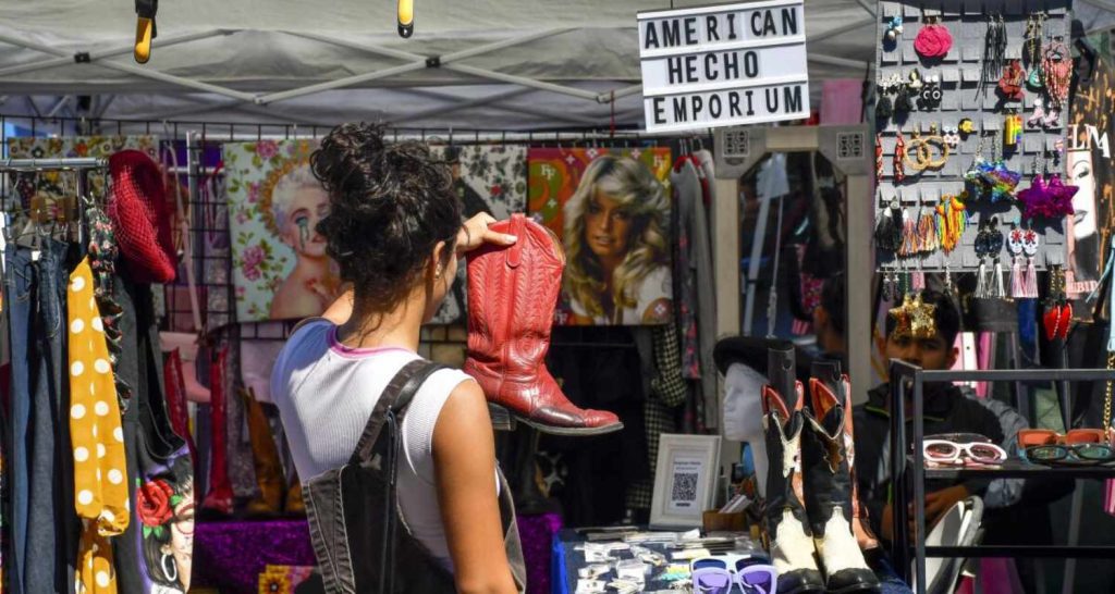 Vintage clothing vendors at a California flea market selling retro fashion and accessories