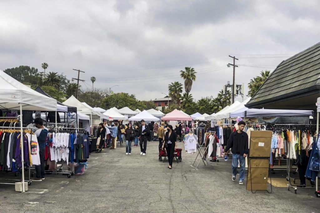 People browsing clothing stalls and vintage apparel vendors at Silverlake Flea Market
