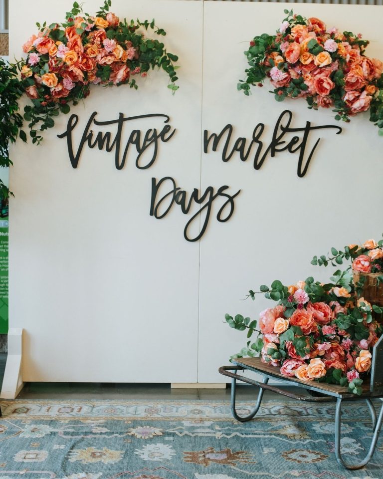 Vintage Market Days Lexington event sign with floral decorations at vintage market vendor event