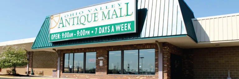 Exterior view of Ohio Valley Antique Mall in Fairfield, Ohio, near Cincinnati, showing visitors entering the large red-brick antique shopping center.