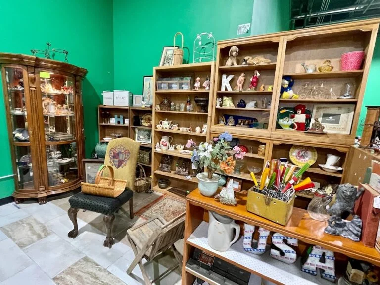Interior view of Plano Antique Mall in Texas featuring vintage furniture, collectibles, and decorative antiques displayed in well-lit booths.