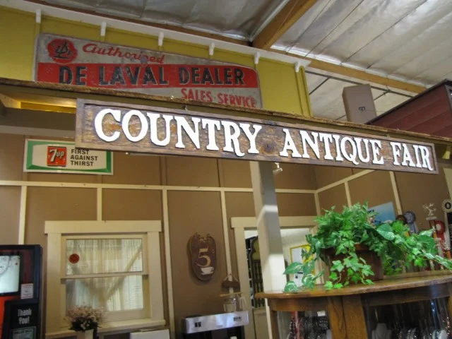 Interior view of Country Antique Fair Mall in Saugus, California, showing indoor vendor booths with antiques and vintage collectibles