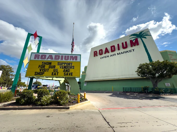 The Roadium Open Air Market in Torrance, California with outdoor vendor stalls, shoppers, fresh produce, and local marketplace atmosphere.