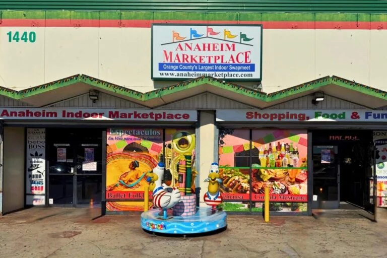 Shoppers walking through Anaheim Indoor Marketplace with multiple indoor vendor stalls and specialty shops.