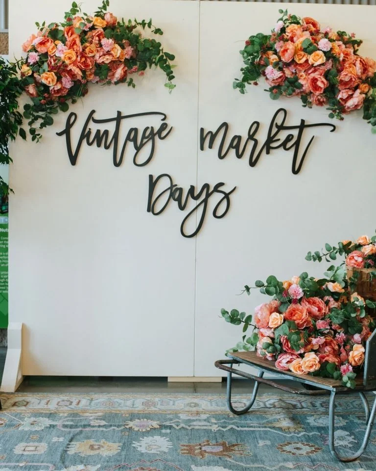 Vintage Market Days Lexington event sign with floral decorations at vintage market vendor event